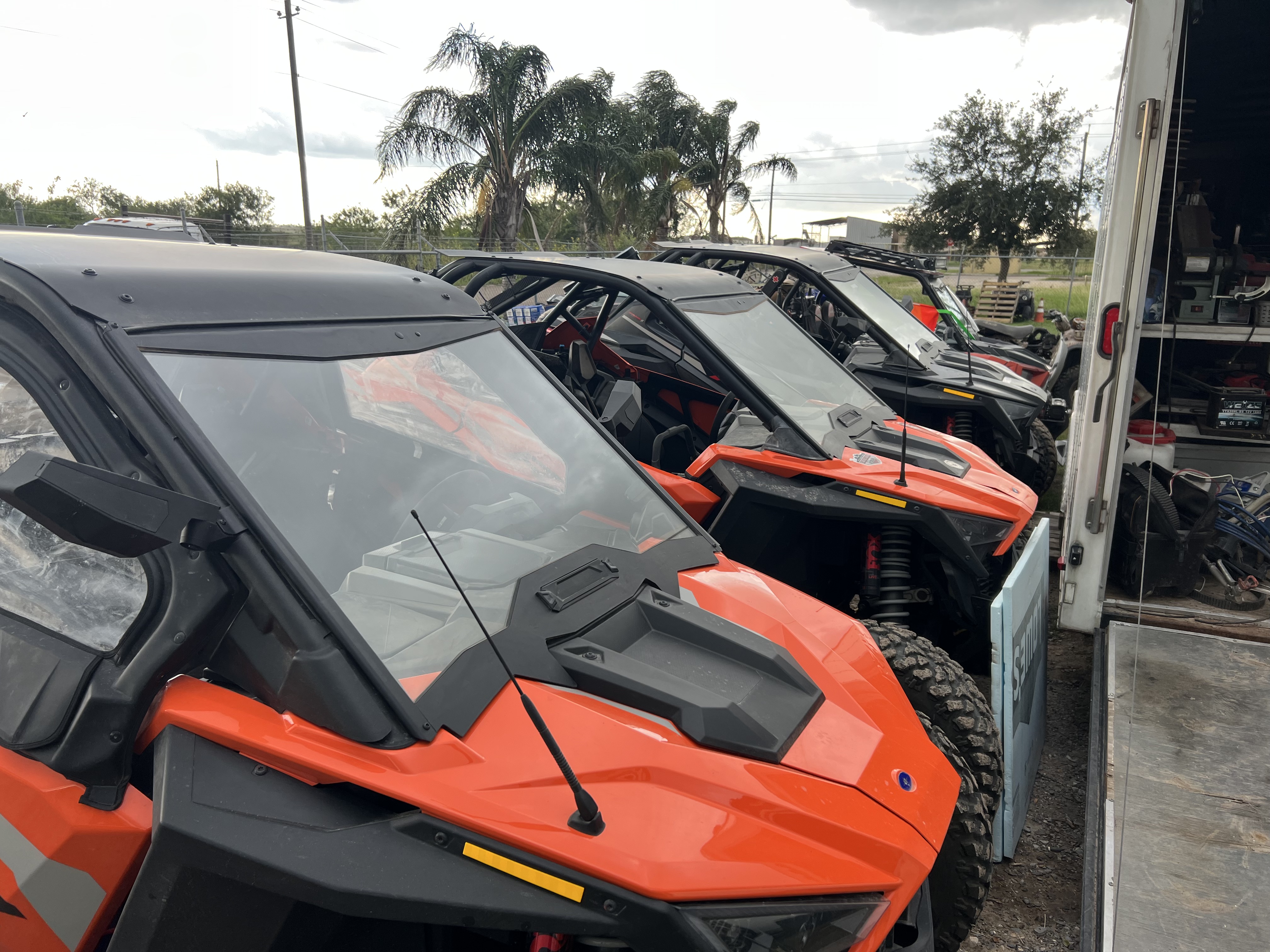 ATVs lined up outside shop